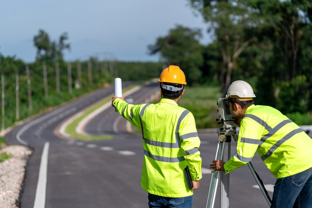 Teamwork,Of,Surveyor,Engineers,Worker,Making,Measuring,With,Theodolite,On